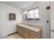 Bathroom boasts a vanity with wood cabinets and a window at 3996 Se 150Th St, Summerfield, FL 34491