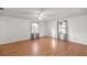 Well-lit bedroom with wood-look floors and grey curtains at 3996 Se 150Th St, Summerfield, FL 34491