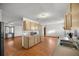 Open kitchen layout with light wood cabinets and laminate floor at 3996 Se 150Th St, Summerfield, FL 34491