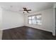 Bright bedroom with dark wood floors and a ceiling fan at 4098 Sw 51 St, Ocala, FL 34474