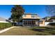 Back of house showing two stories, patio, and landscaping at 4098 Sw 51 St, Ocala, FL 34474