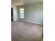 Spacious bedroom with carpeted floor and large window at 421 Spring Ln, Ocala, FL 34472