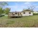 Home exterior showcasing a deck and grassy backyard at 4377 Ne 13Th St, Ocala, FL 34470