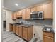 Basement kitchenette with wood cabinets, granite countertops, and subway tile backsplash at 4377 Ne 13Th St, Ocala, FL 34470