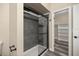 Clean bathroom with gray tile, a shower/tub combo, and built-in shelving at 4377 Ne 13Th St, Ocala, FL 34470