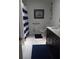 Bathroom with dark vanity and nautical shower curtain at 4434 Se 10Th Pl, Ocala, FL 34471