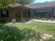 Home's exterior, featuring a walkway, landscaping, and wood pile at 4434 Se 10Th Pl, Ocala, FL 34471