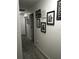 Bright hallway with framed photos and light grey carpet at 4434 Se 10Th Pl, Ocala, FL 34471