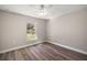 Bright bedroom with ceiling fan and wood-look flooring at 46 Locust Pass Run, Ocala, FL 34480