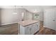 Kitchen island with granite countertop and white cabinets at 46 Locust Pass Run, Ocala, FL 34480