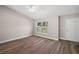 Living room with vinyl plank flooring, large window, and access to the front door at 46 Locust Pass Run, Ocala, FL 34480