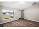 Living room with vinyl plank flooring, large window, and access to the front door at 46 Locust Pass Run, Ocala, FL 34480