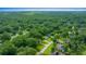 Aerial view showcasing home's setting in a wooded residential area at 4977 Se 44Th Cir, Ocala, FL 34480