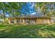 House exterior showcasing a large backyard and screened porch at 4977 Se 44Th Cir, Ocala, FL 34480