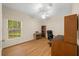 Bedroom with wood floors, a desk, and built-in shelving at 4977 Se 44Th Cir, Ocala, FL 34480