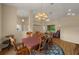 Bright dining room featuring a wood table and chairs, hardwood floors, and a chandelier at 4977 Se 44Th Cir, Ocala, FL 34480