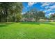 Landscaped yard with a one-story house and lush green grass at 4977 Se 44Th Cir, Ocala, FL 34480