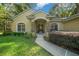 Front entrance with walkway, landscaping, and a double door entry at 4977 Se 44Th Cir, Ocala, FL 34480