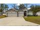 Two-car garage and stone accents on a charming house exterior at 5053 Se 89Th St, Ocala, FL 34480