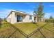 Fenced backyard with grass, a tree, and a patio at 5325 Sunshine Dr, Wildwood, FL 34785