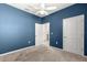 Blue bedroom with ceiling fan and access to bathroom at 5325 Sunshine Dr, Wildwood, FL 34785