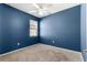 Blue bedroom with ceiling fan and carpeting at 5325 Sunshine Dr, Wildwood, FL 34785