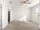 Bright bedroom with carpeted floor, ceiling fan, and ensuite bathroom at 5325 Sunshine Dr, Wildwood, FL 34785