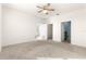 Spacious bedroom with carpet, ceiling fan, and access to bathroom and closet at 5325 Sunshine Dr, Wildwood, FL 34785