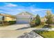 Two-story house with a gray exterior, two-car garage, and landscaping at 5325 Sunshine Dr, Wildwood, FL 34785