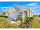 Front view of a single-story house with a gray exterior and landscaping at 5325 Sunshine Dr, Wildwood, FL 34785