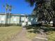 Light green condo building with a sidewalk and landscaping at 533 Midway Dr # B, Ocala, FL 34472