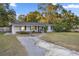 Ranch home with gray siding, walkway, and a spacious yard at 536 Ne 43Rd Ave, Ocala, FL 34470