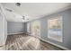 Bright living room featuring hardwood floors and French doors leading to the backyard at 536 Ne 43Rd Ave, Ocala, FL 34470