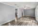 Bright living room features wood-look floors, a ceiling fan, and natural light from the windowed door at 536 Ne 43Rd Ave, Ocala, FL 34470