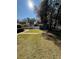 Backyard with shed, grass, trees, and brick pathway at 5579 Se 44Th Cir, Ocala, FL 34480