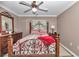 Bedroom with a wooden bed frame and red blanket at 5579 Se 44Th Cir, Ocala, FL 34480