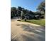 Side view of the house with a paved driveway and landscaped yard at 5579 Se 44Th Cir, Ocala, FL 34480