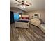 Main bedroom with wood-look floors and ceiling fan at 5579 Se 44Th Cir, Ocala, FL 34480