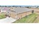 Rear view of tan house with screened patio and garage at 6158 Sw 88Th Loop, Ocala, FL 34476