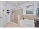 Spa-like bathroom with a large shower and a relaxing soaking tub at 6158 Sw 88Th Loop, Ocala, FL 34476