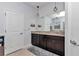 Double vanity bathroom with granite countertop and dark brown cabinets at 6158 Sw 88Th Loop, Ocala, FL 34476