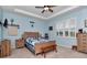 Serene bedroom with a queen-size bed, wooden furniture, and a ceiling fan at 6158 Sw 88Th Loop, Ocala, FL 34476