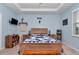 Main bedroom with light blue walls, wooden bed, and plenty of natural light at 6158 Sw 88Th Loop, Ocala, FL 34476