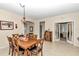 Elegant dining room with a wooden table and access to other rooms at 6158 Sw 88Th Loop, Ocala, FL 34476