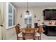 Charming kitchen nook with wood table and window seating at 6158 Sw 88Th Loop, Ocala, FL 34476