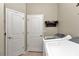 Bright laundry room with washer, dryer, and storage at 6158 Sw 88Th Loop, Ocala, FL 34476