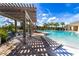 Enjoy the shade under the pergola next to the refreshing community pool at 6158 Sw 88Th Loop, Ocala, FL 34476