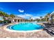 Resort-style pool with lounge chairs and a shaded seating area at 6158 Sw 88Th Loop, Ocala, FL 34476