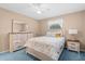 Bright bedroom with wood furniture and blue carpet at 7994 Se 174Th Belhaven Loop, The Villages, FL 32162