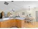 Open concept dining area with hardwood floors and a farmhouse table at 7994 Se 174Th Belhaven Loop, The Villages, FL 32162